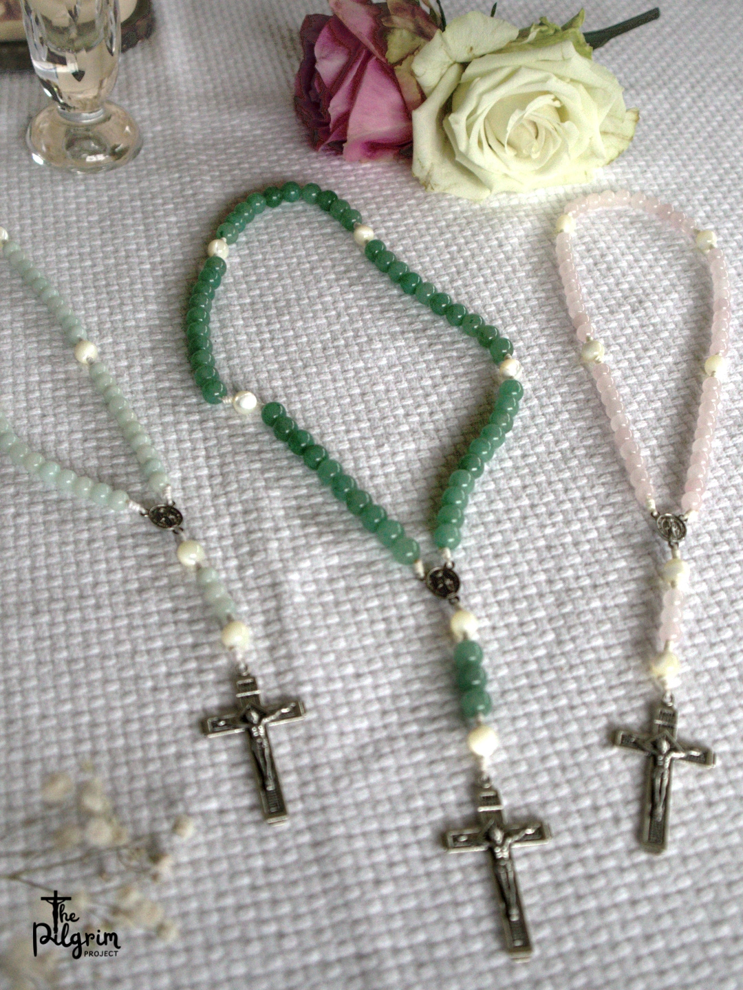 Three hand-crafted cord rosaries made of semi-precious gemstone, blue, green and rose.